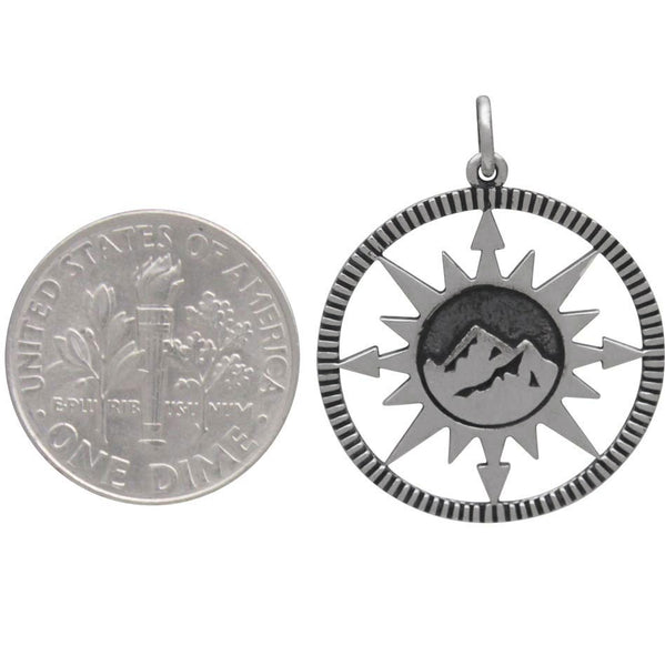Sterling silver compass charm with mountain top design in the center Size Comparison
